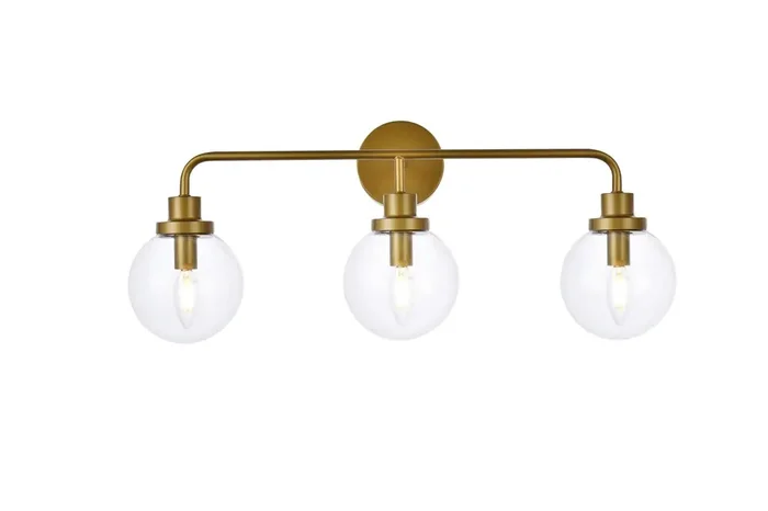 Elegant Furniture & Lighting – Hanson 3 lights bath sconce in brass with clear shade – LD7035W28BR